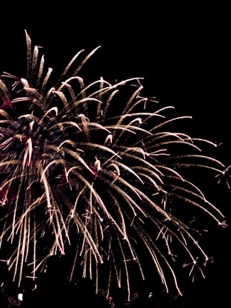 A vibrant drone light show forming a dynamic pattern against a dark night sky