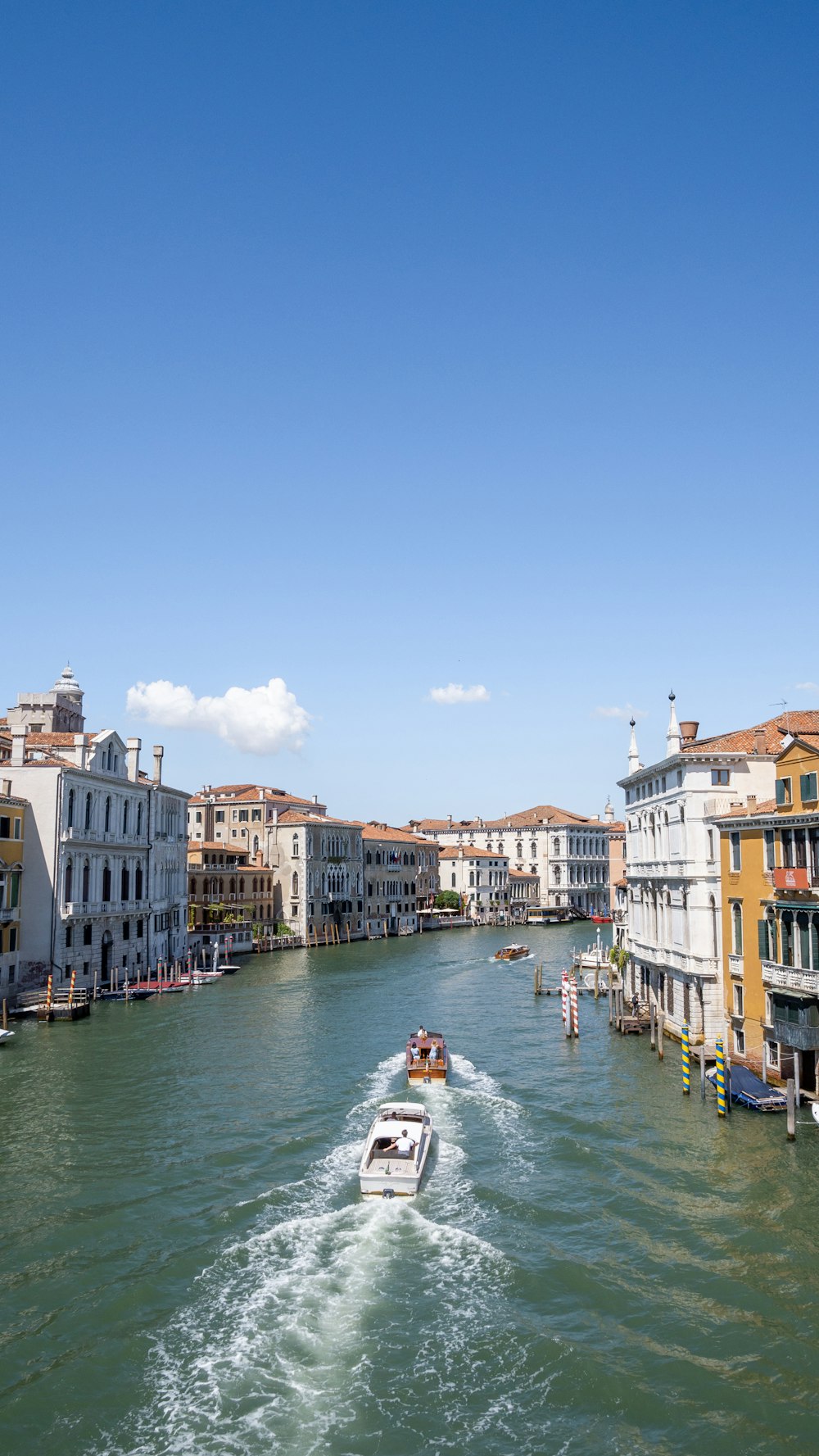 a river with boats in it and buildings around it