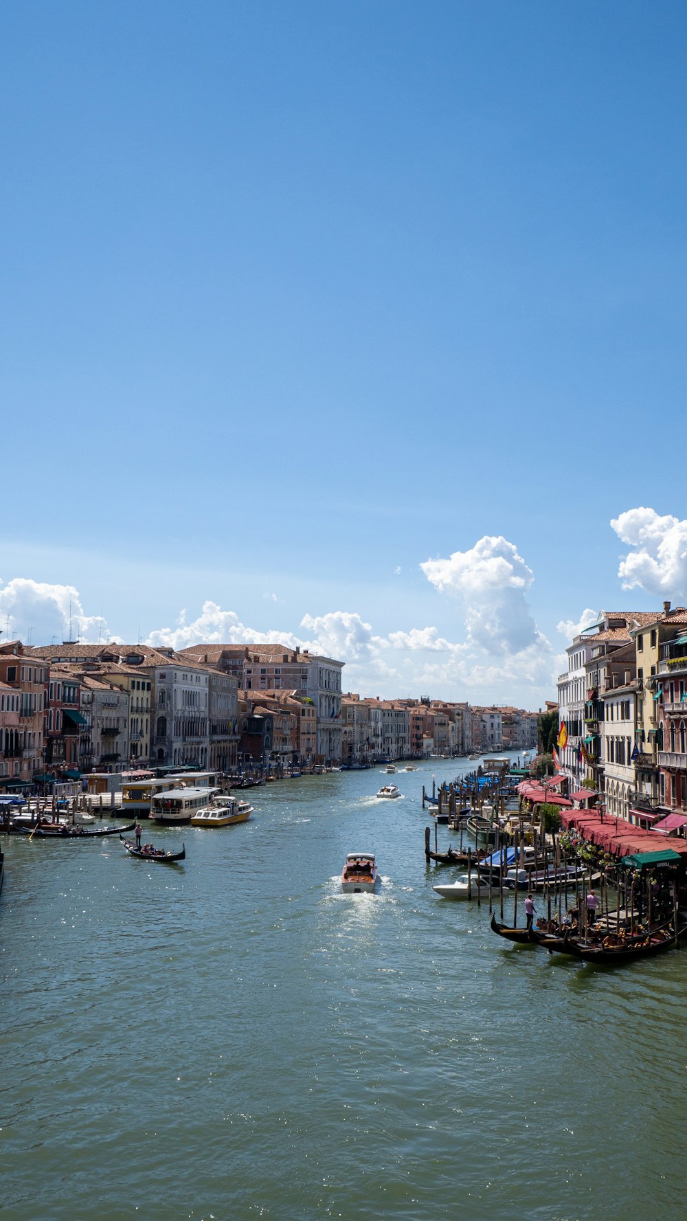 a body of water with boats in it and buildings around it