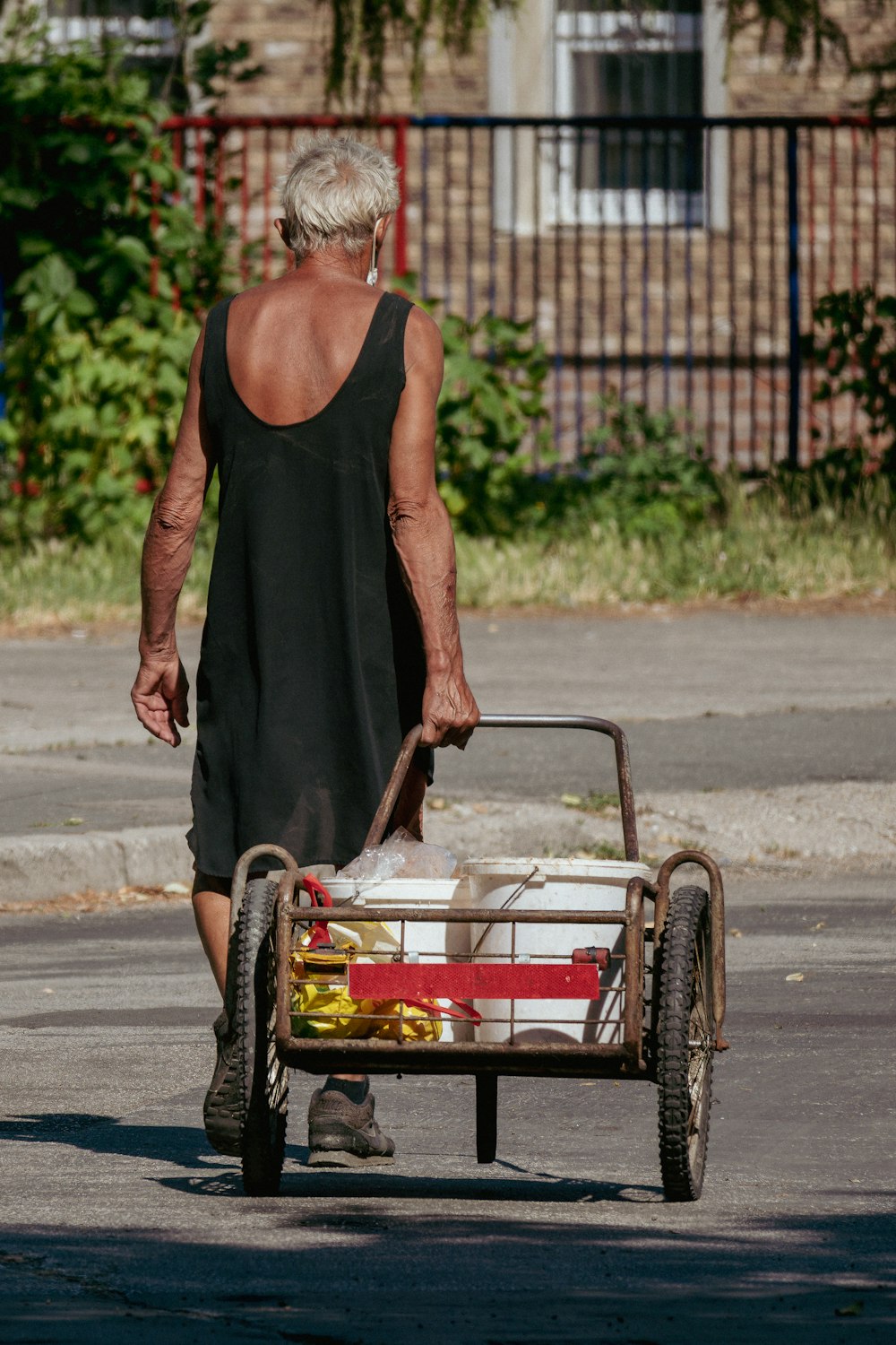 a person pushing a cart with a basket on it