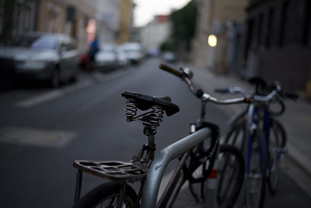 a row of bicycles parked on the side of a street