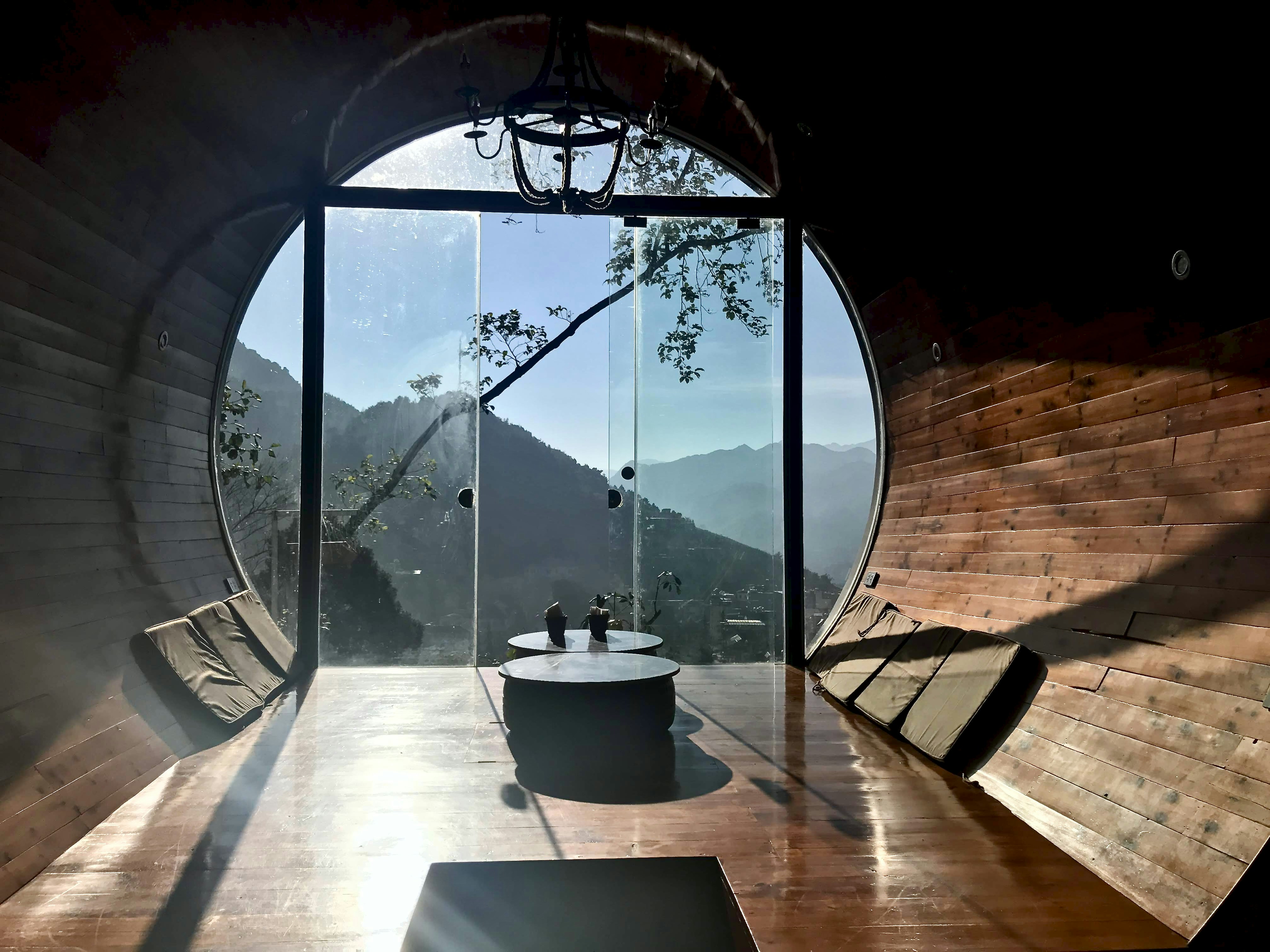 a large window with a view of a city and a river, Capsule hotel in Vietnam 