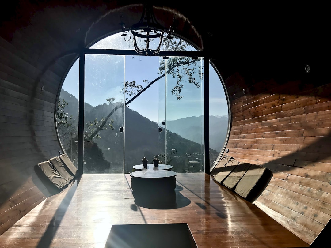 a large window with a view of a city and a river, Capsule hotel in Vietnam