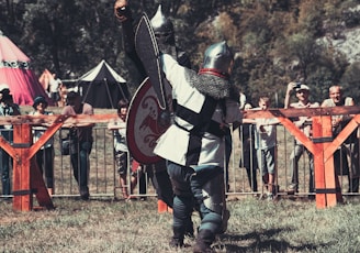 a person in a garment holding a shield and sword