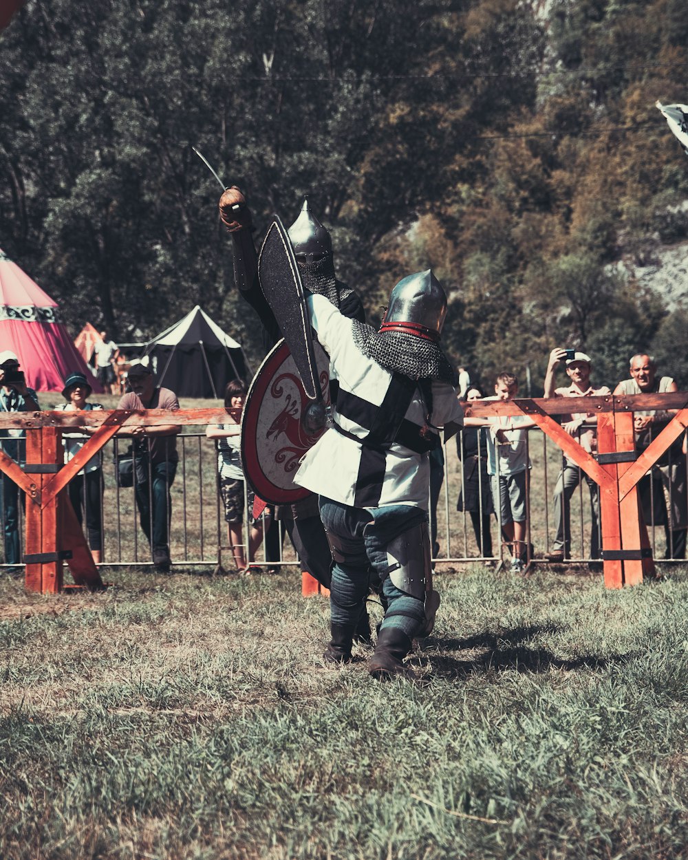 a person in a garment holding a shield and sword