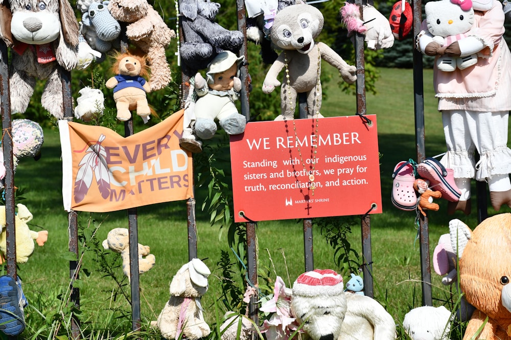 a sign in front of a group of stuffed animals