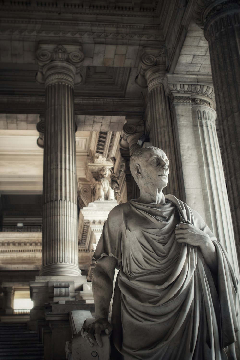 a statue of a person holding a book