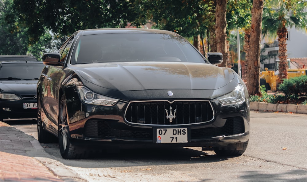 a black car parked on the side of the road