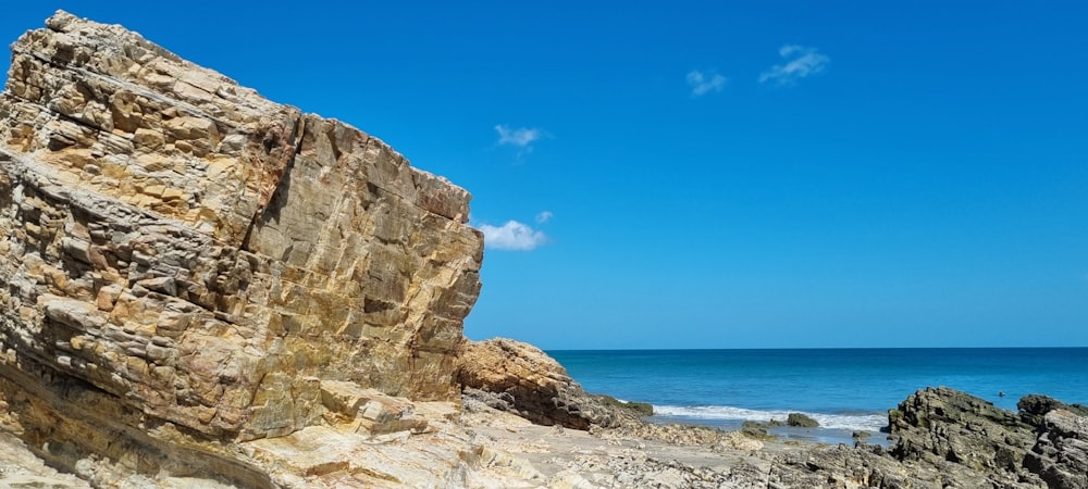 a rocky cliff next to the ocean