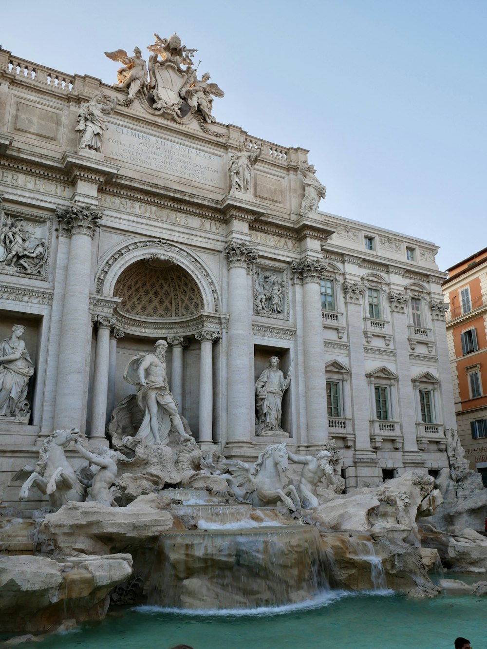 a large building with statues and a fountain in front of it with Trevi Fountain in the background