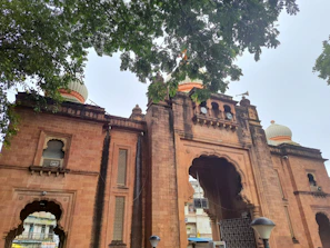 A wide-angle view of the grand entrance arch welcoming visitors to Lakshmi Nivas.