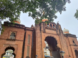 A wide-angle view of the grand entrance arch welcoming visitors to Lakshmi Nivas.