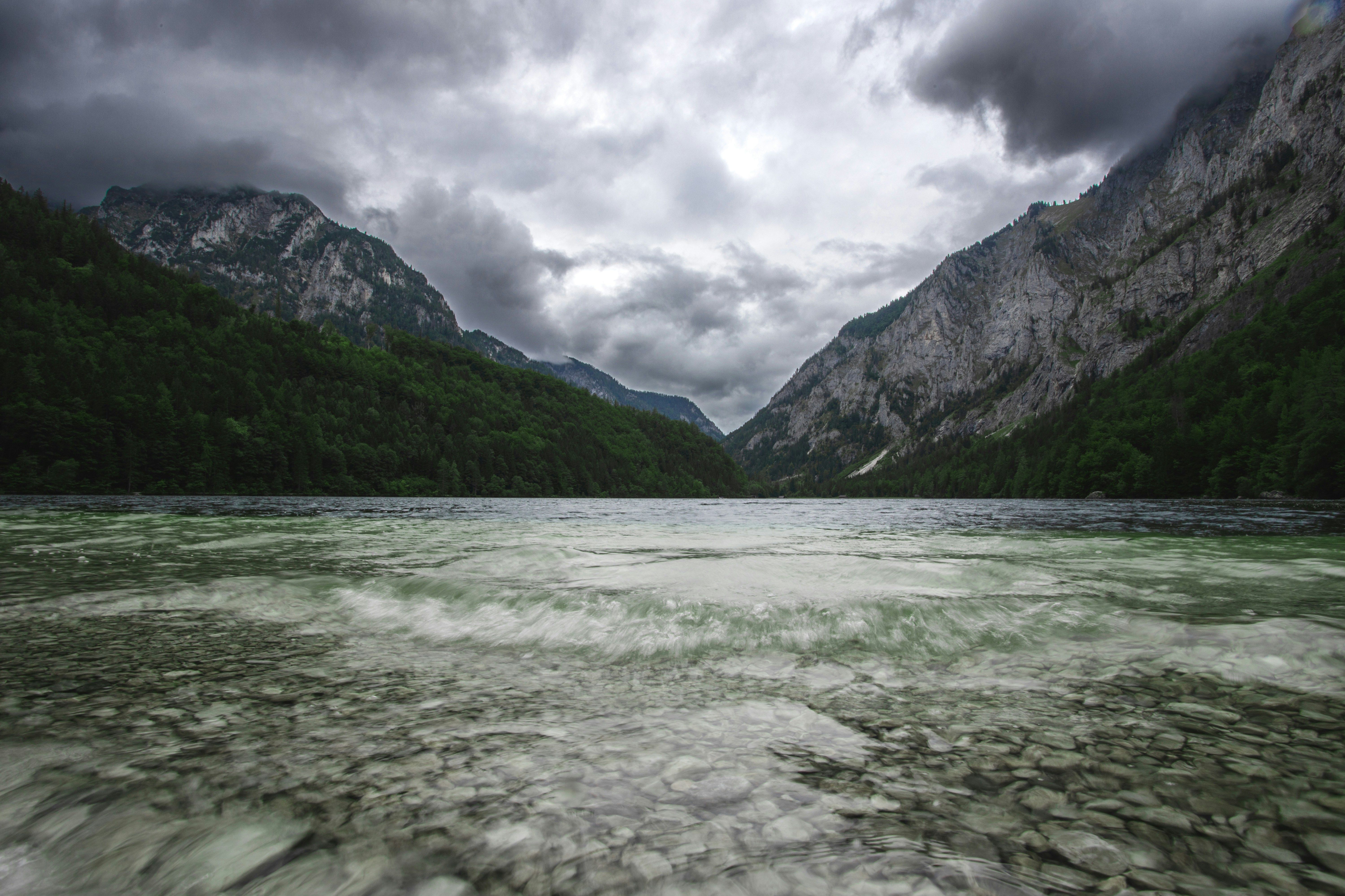 a river running through a valley between mountains