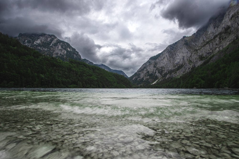 a river running through a valley between mountains