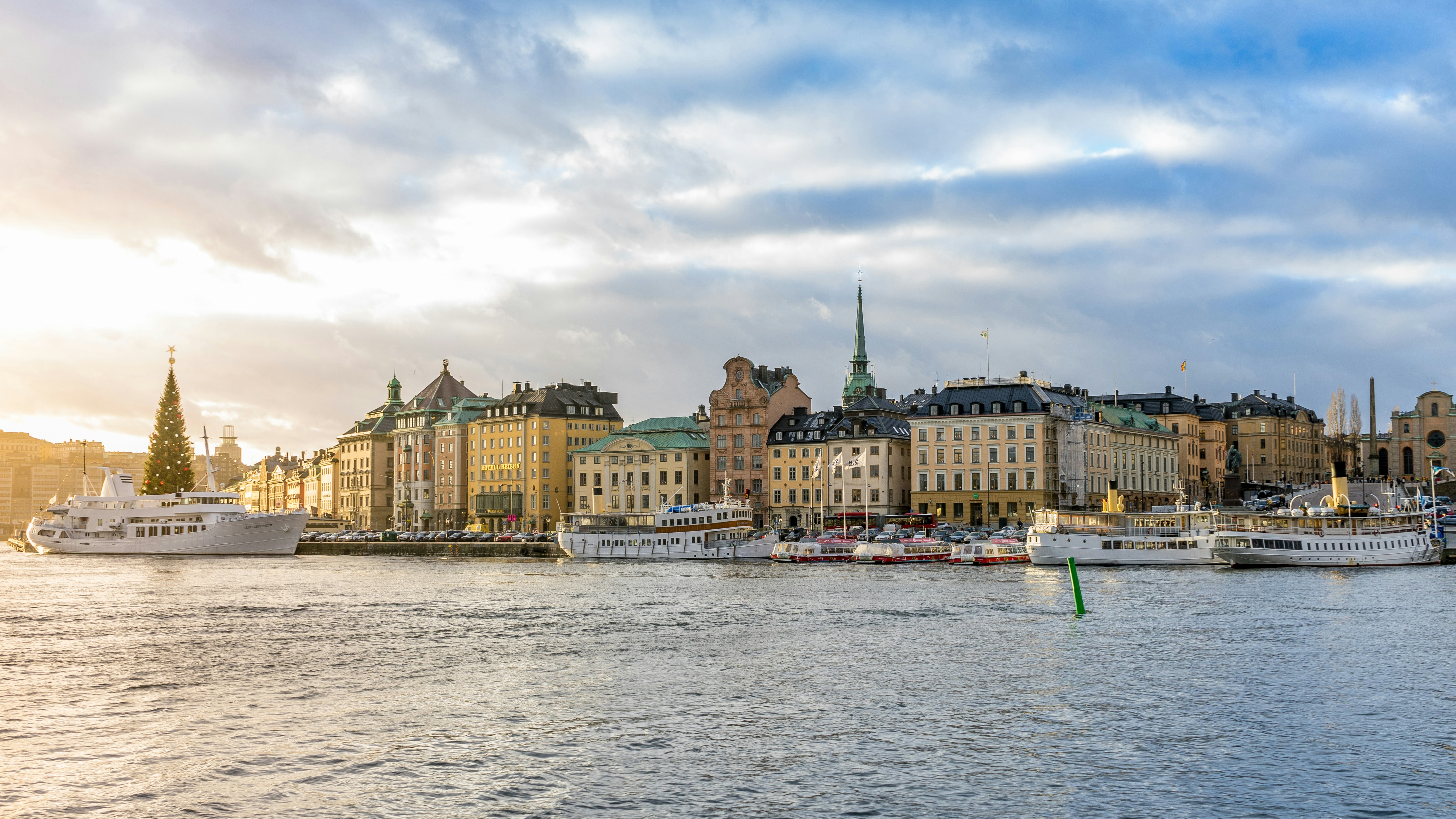 a body of water with boats in it and buildings around it