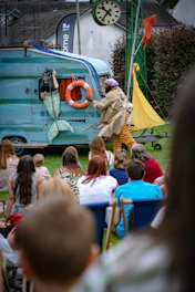a group of people watching a person play a musical instrument
