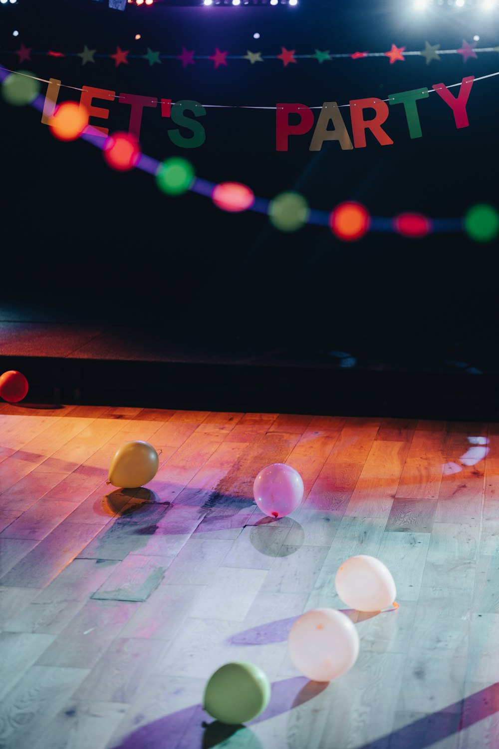 a group of colorful balls on a wooden surface