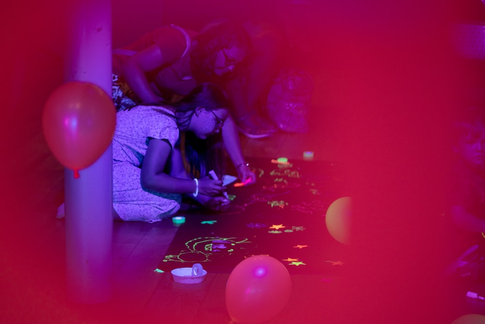 a person lying on the floor with balloons around them