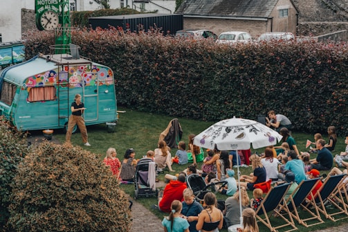 a crowd of people sitting on the grass