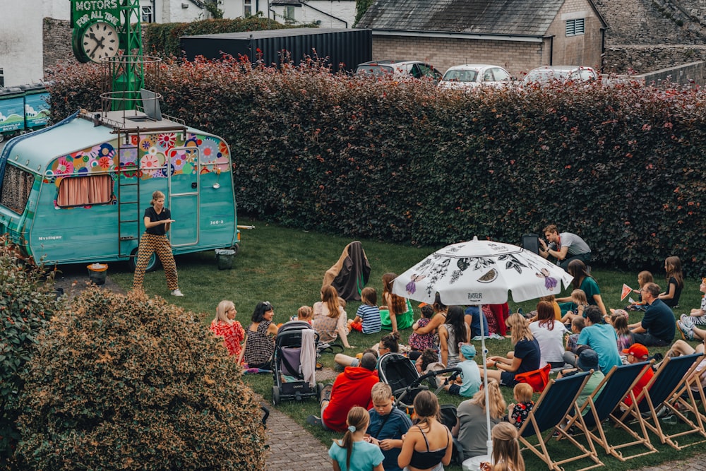 a crowd of people sitting on the grass