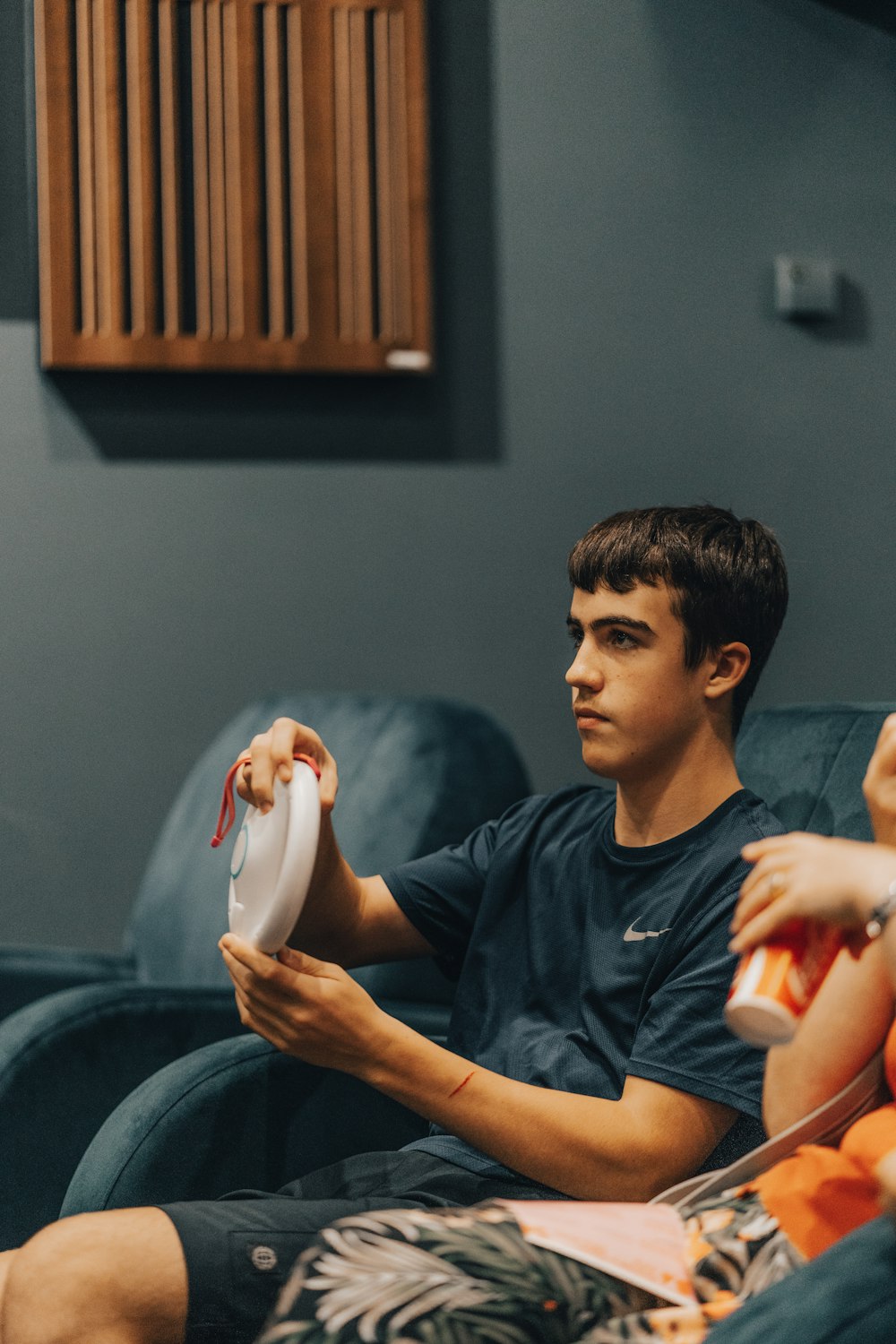 a man sitting on a couch playing video games