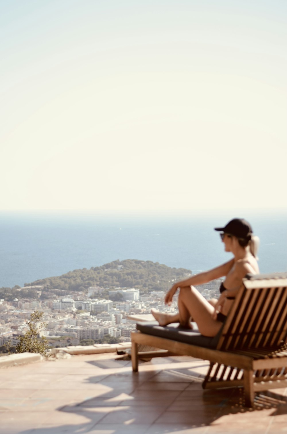 a person sitting on a bench overlooking a city