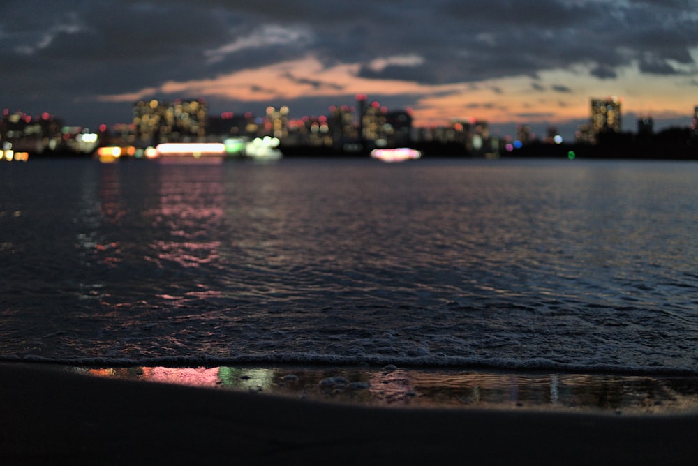 a body of water with a city in the background