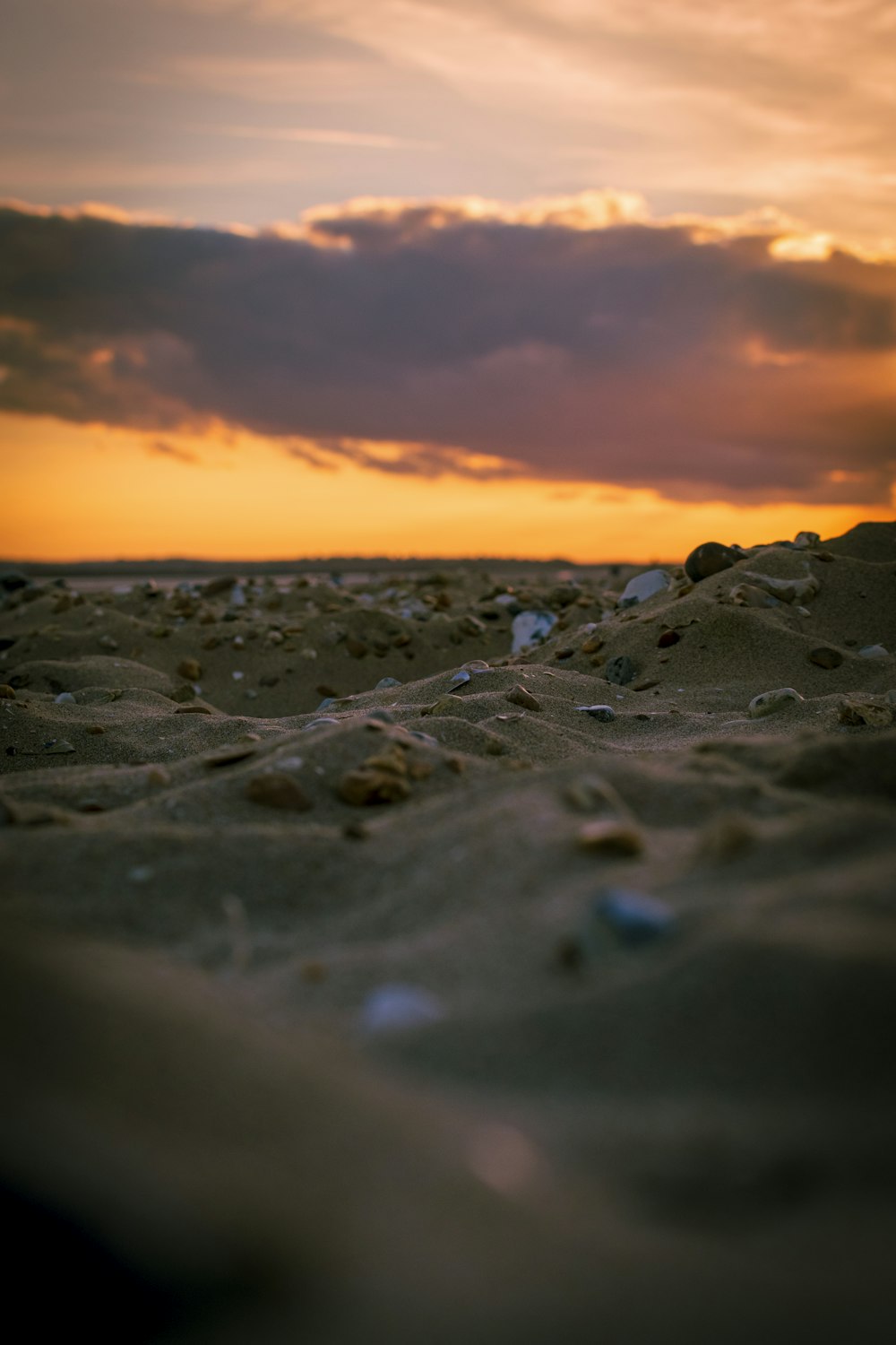 a rocky beach with a sunset