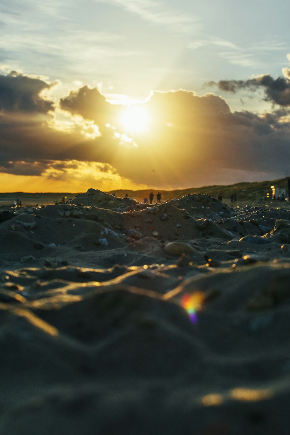 a rocky beach with the sun setting