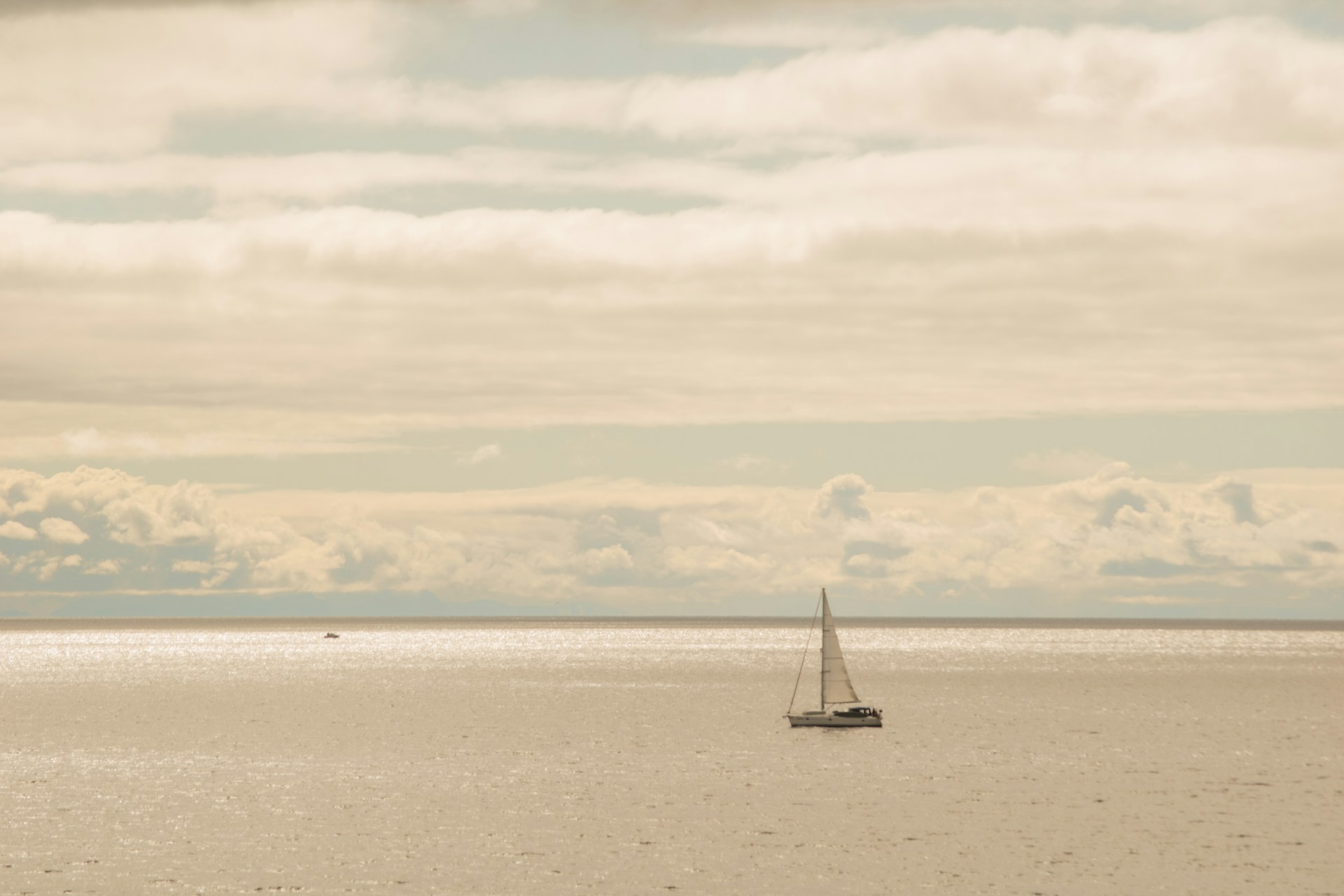 woman wearing yellow long-sleeved dress under white clouds and blue sky during daytime