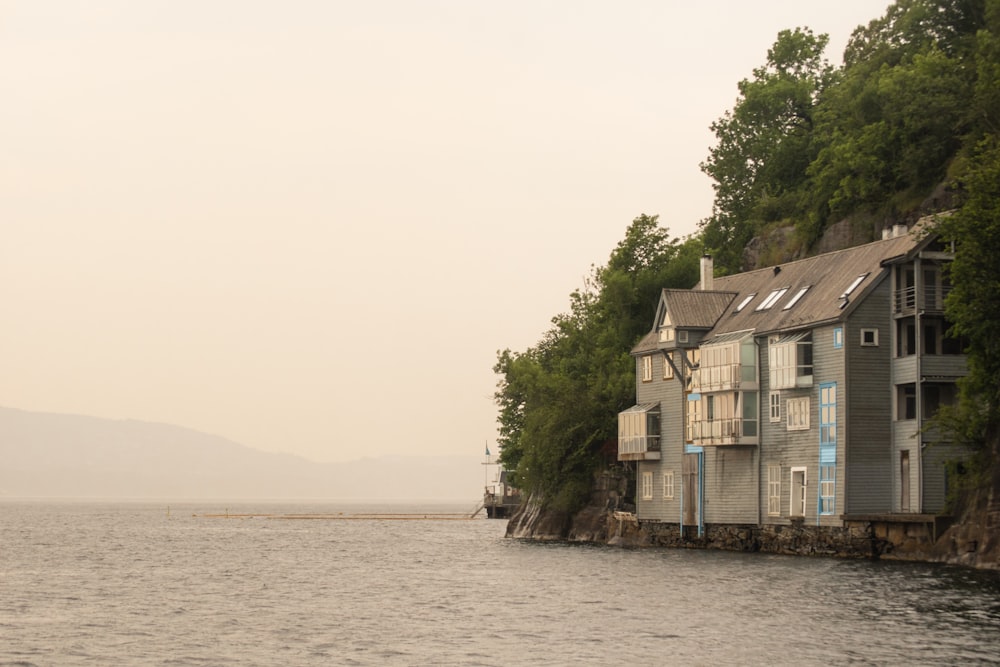 a row of houses on a rocky shore