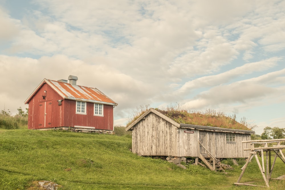 a red house in a grassy field