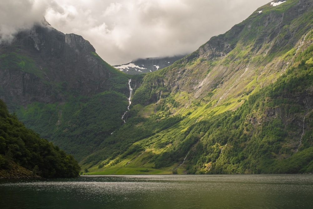 a body of water with mountains in the back