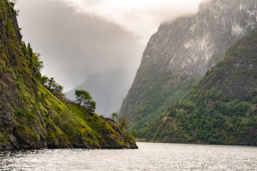 a body of water with mountains on the side