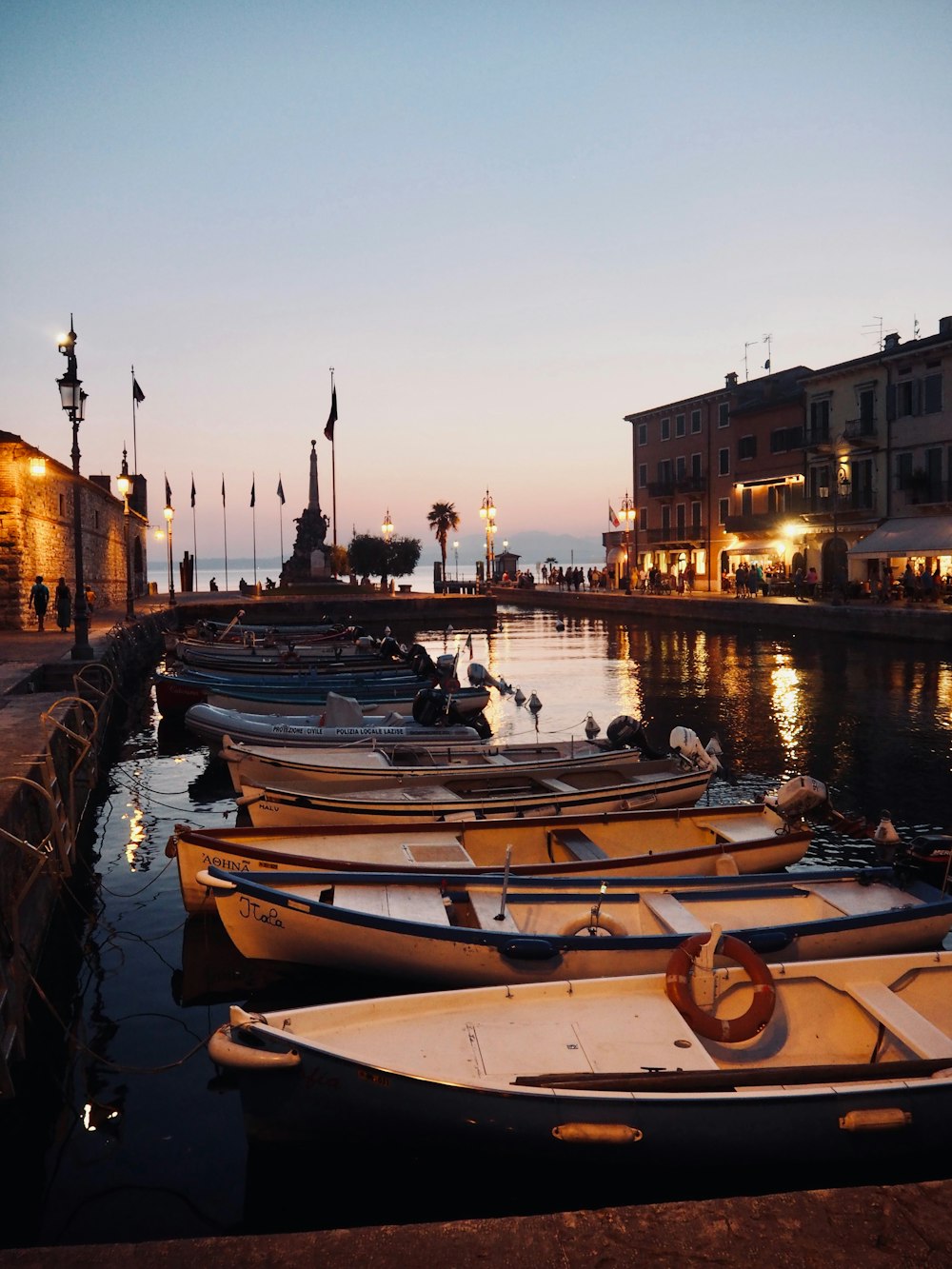 a group of boats sit in a harbor