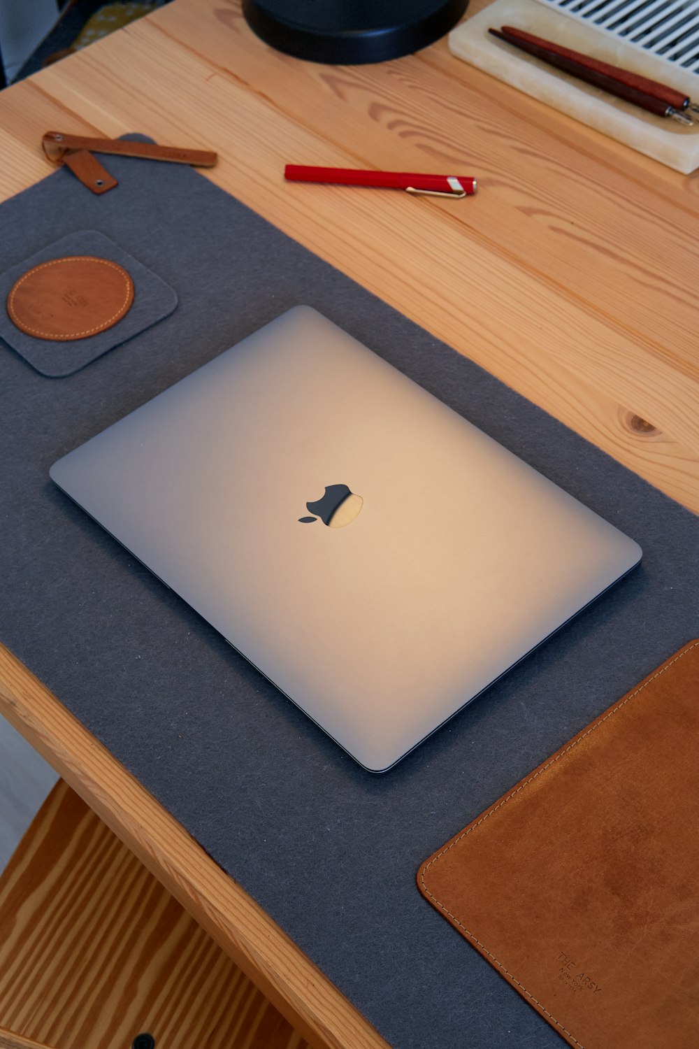 a white laptop on a wooden table