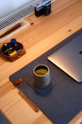 a coffee cup and a laptop on a table