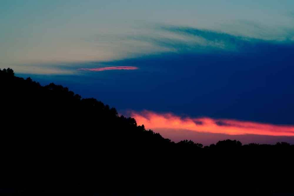 a sunset over a forest