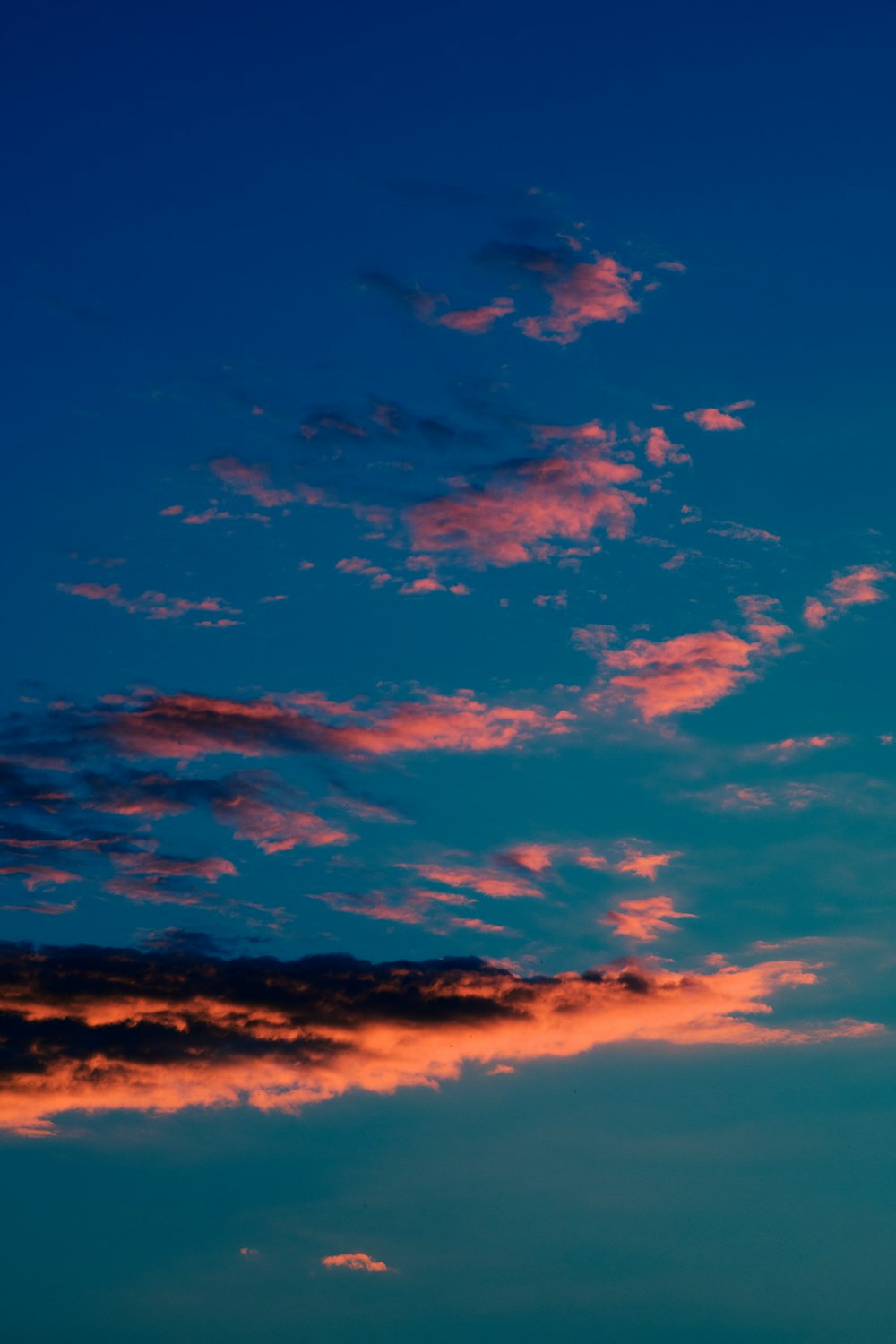 a blue sky with pink clouds