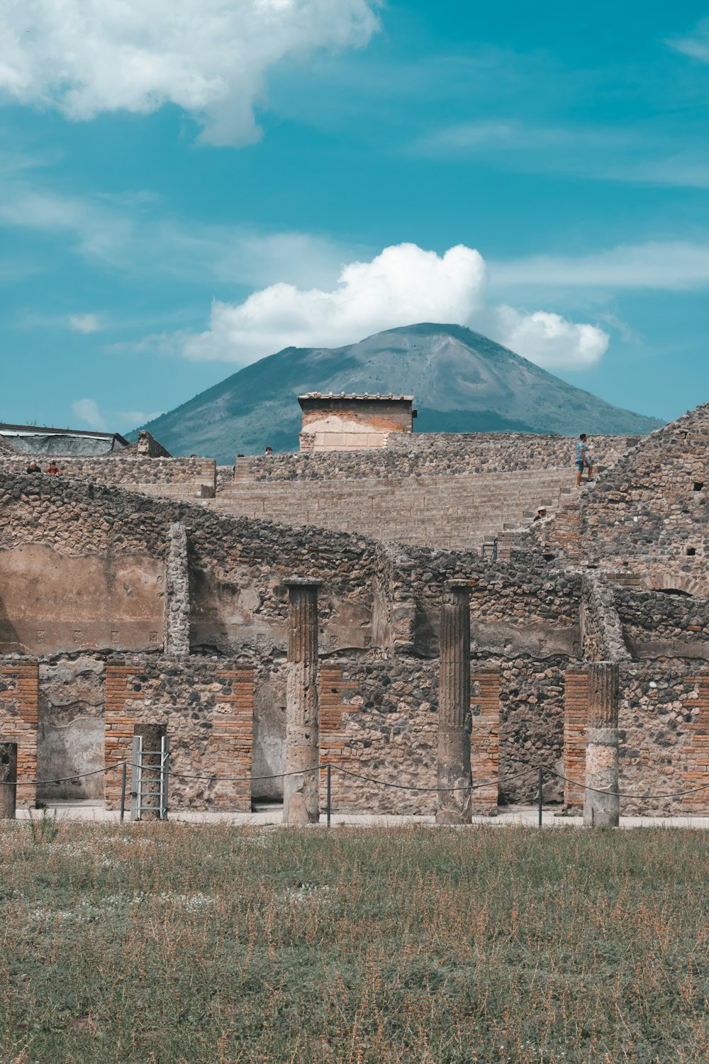 a stone building with a mountain in the background