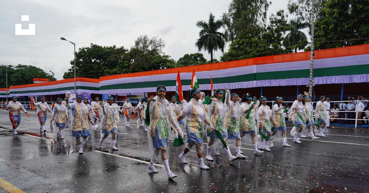 A group of people marching in a parade photo – Free Parade Image on ...