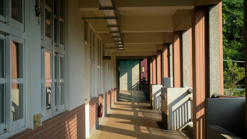 Covered walkway between two modern school buildings, similar to the new campus layout at Von Tobel Middle School