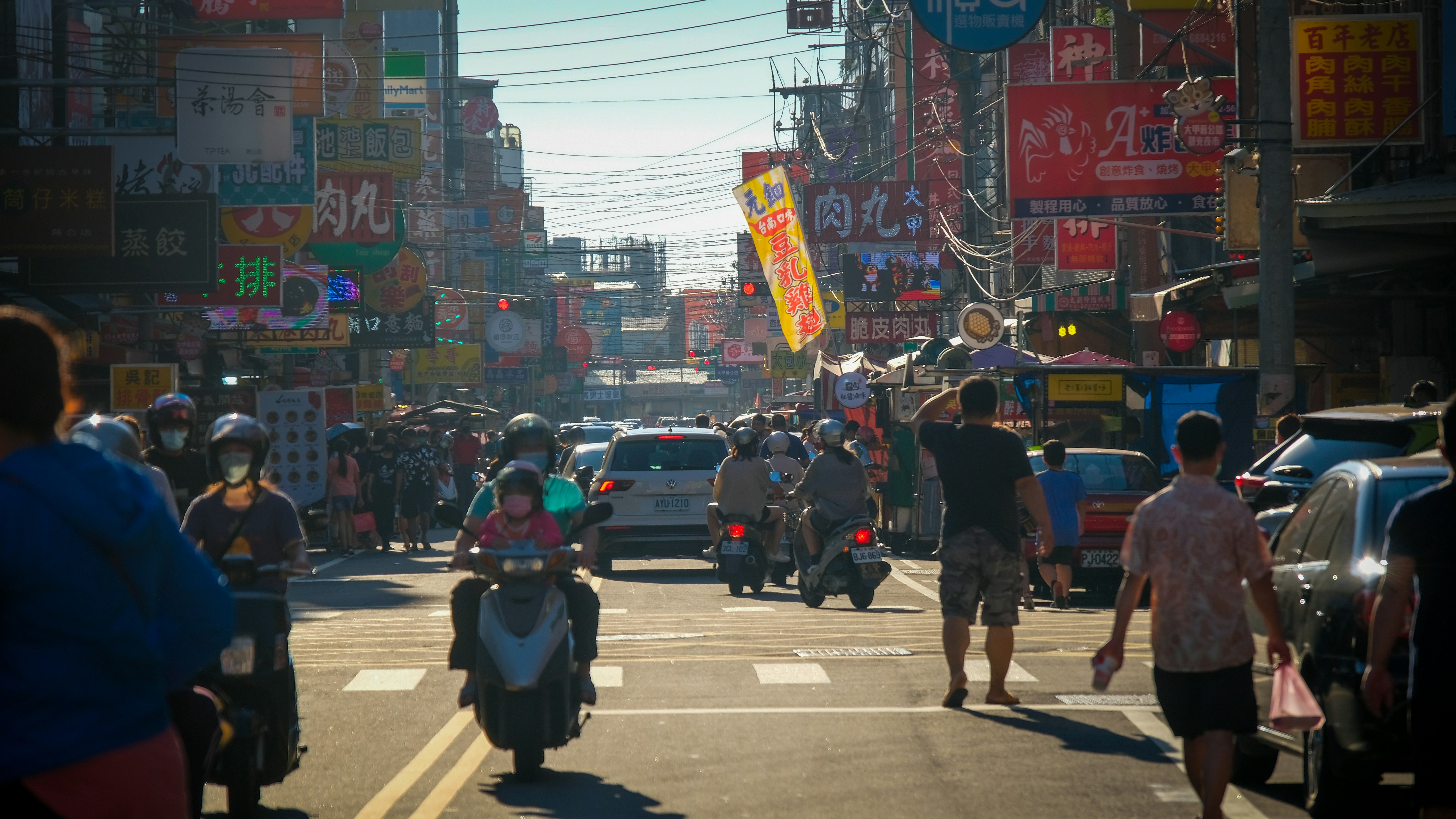 a busy street with many people and cars