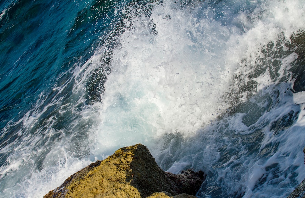 a wave crashing on a rock