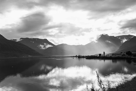 a body of water with mountains in the background
