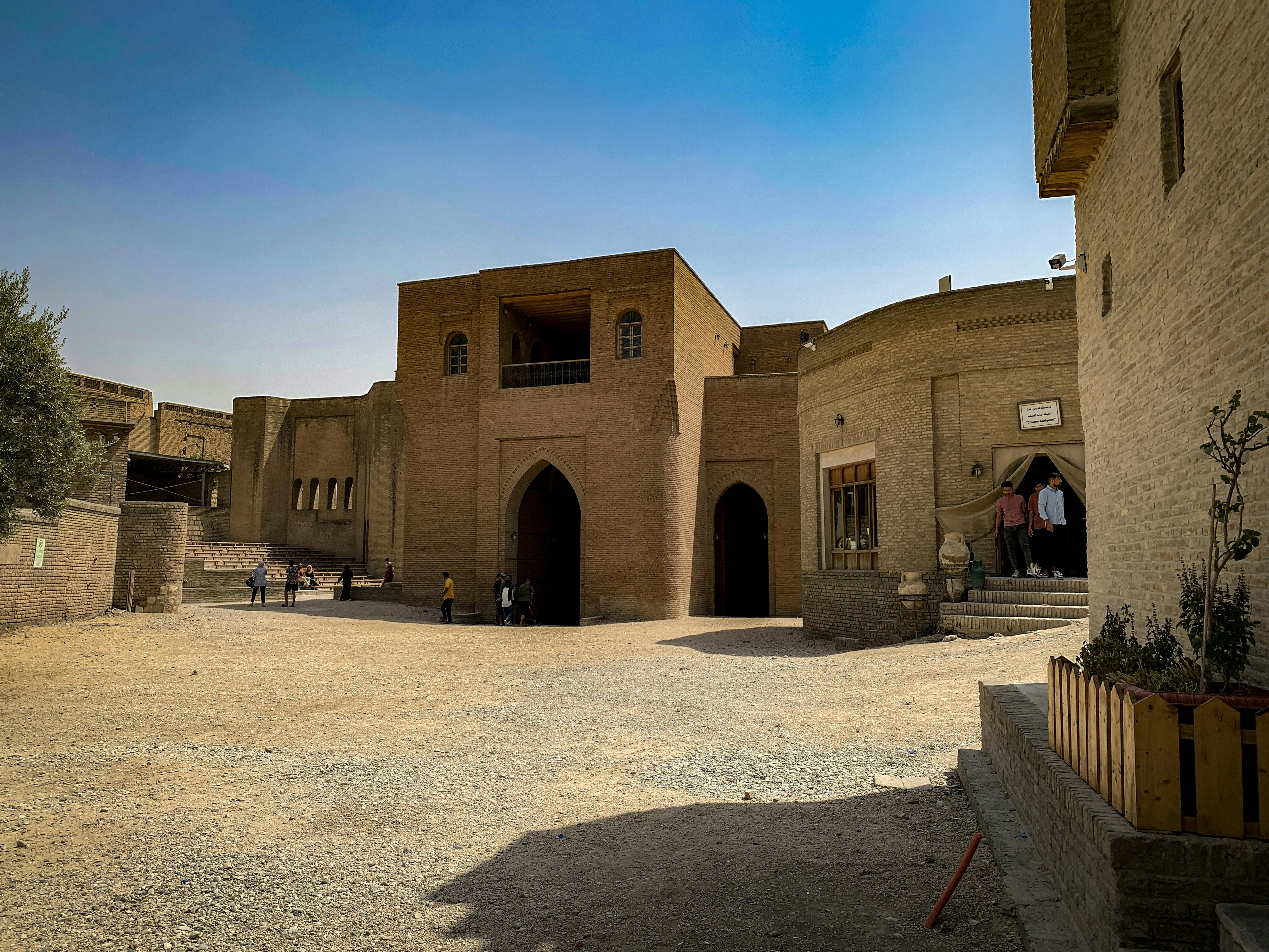 a stone building with people walking around