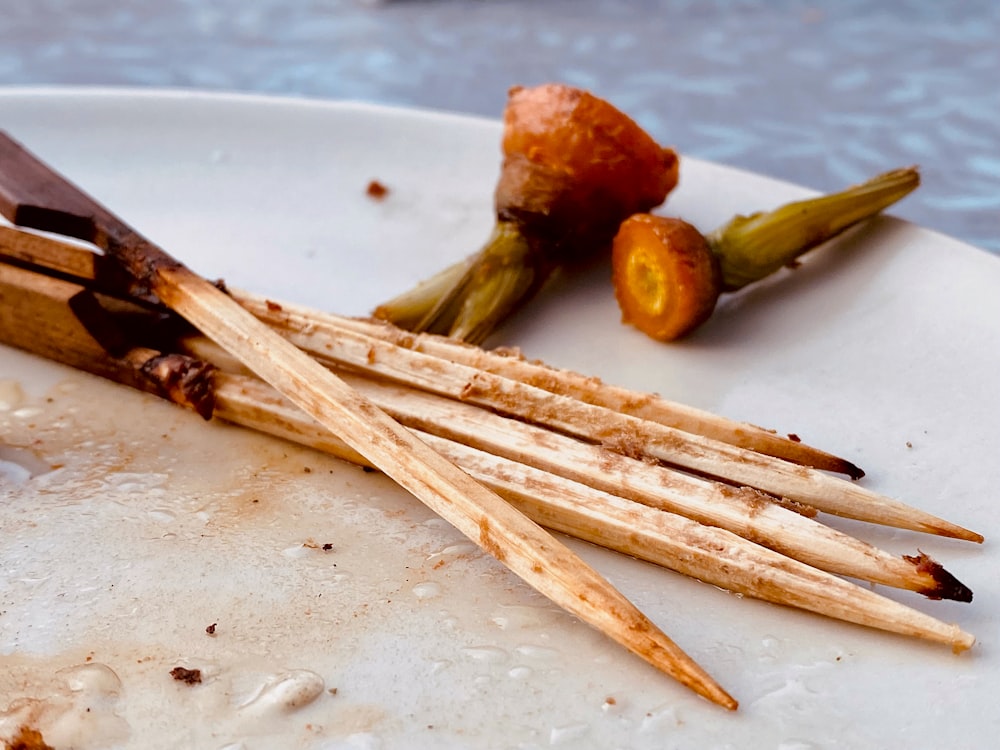 a group of sticks with food on them