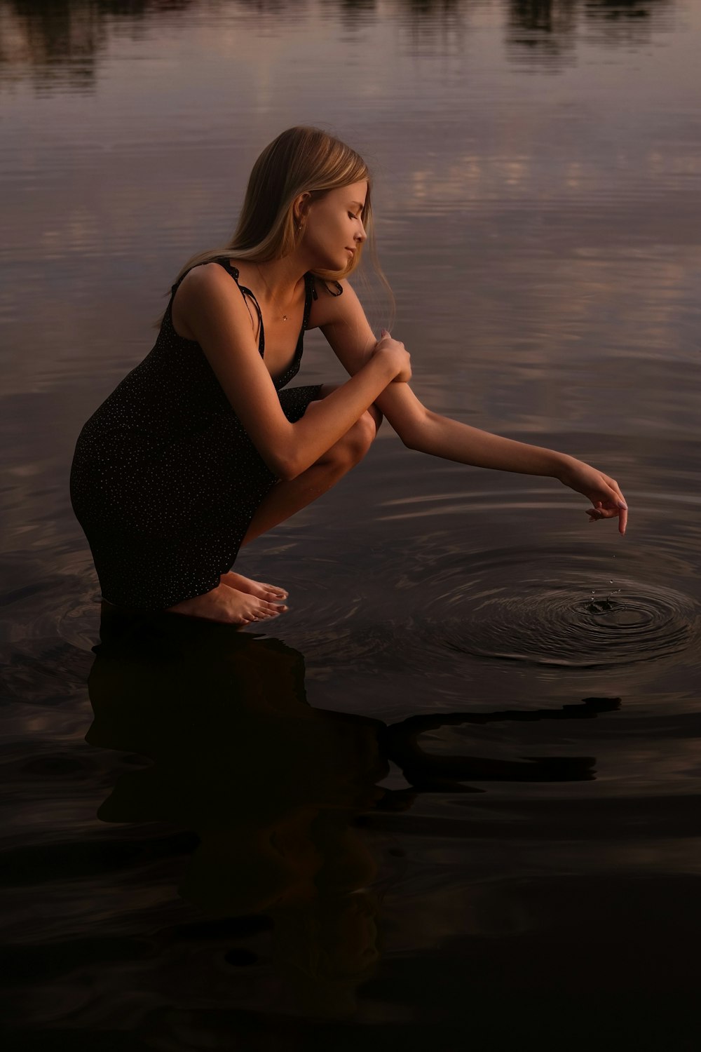a woman sitting on the water