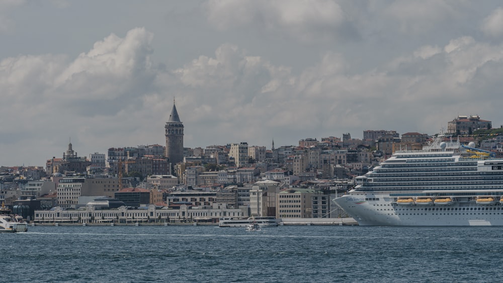 a large cruise ship in front of a city