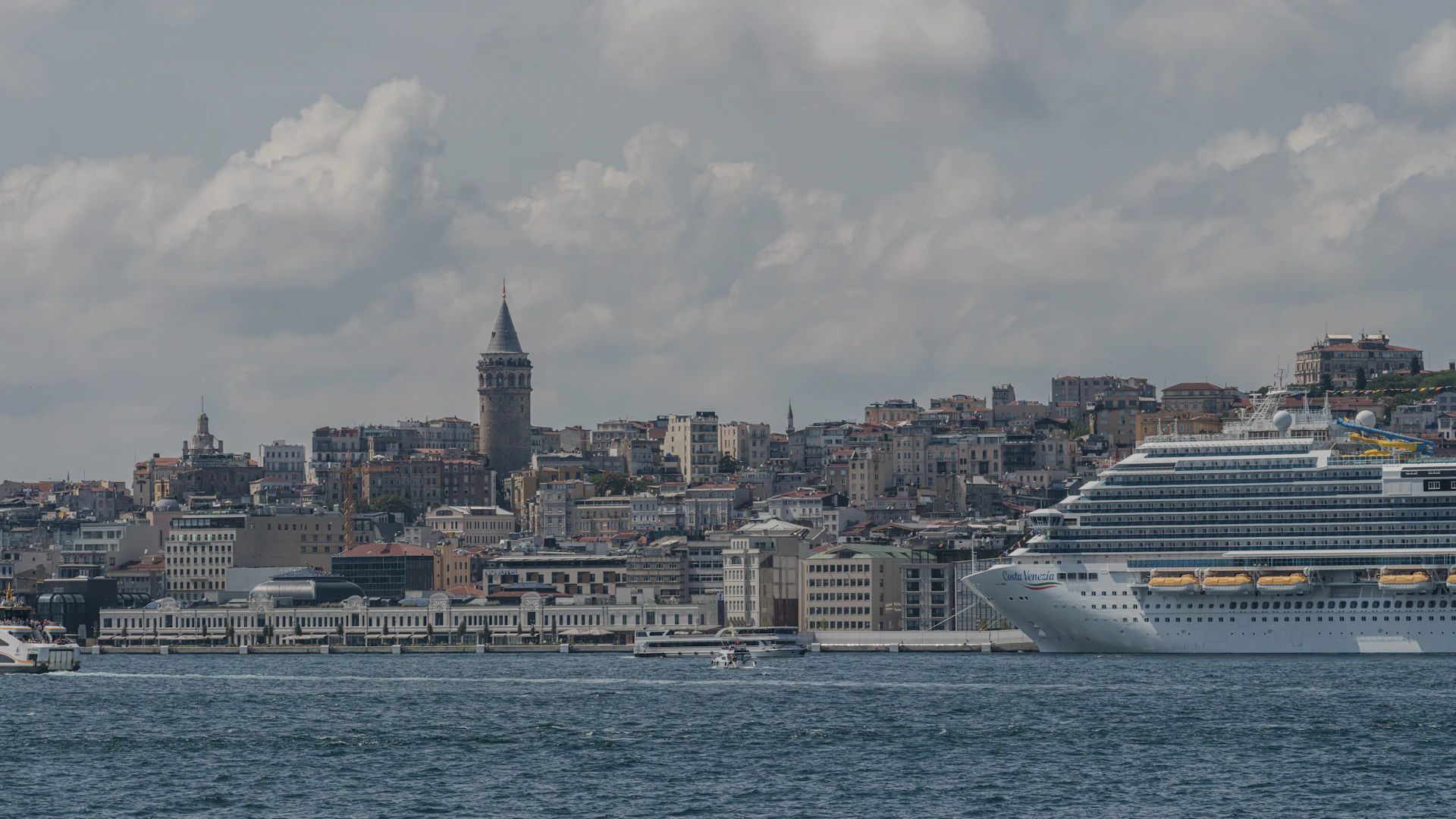 a large cruise ship in front of a city